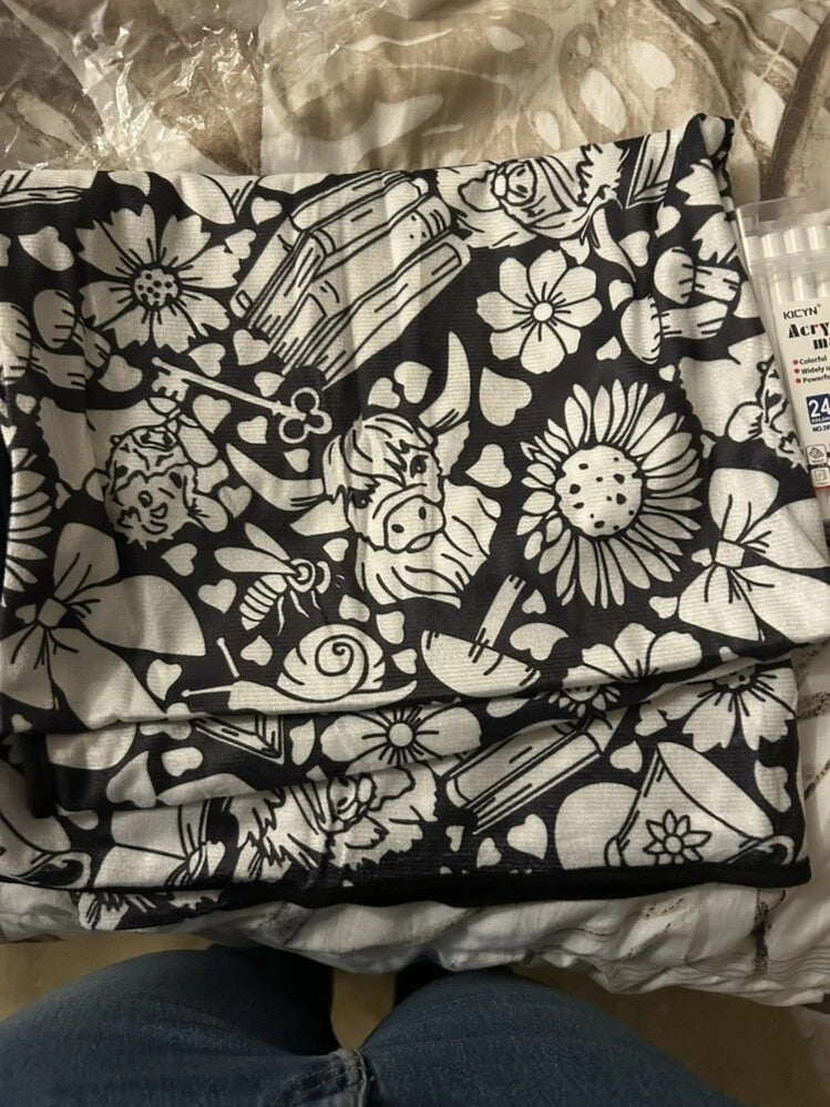 Folded floral colouring blanket and markers